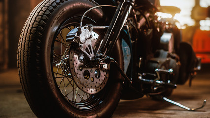 Macro Close Up Wheel Details of a Custom Bobber Motorbike Standing in an Authentic Creative...
