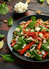 Roasted carrot salad with feta cheese, walnut and spinach. healthy food