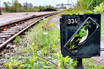 Old track switch on the railway track in the grass