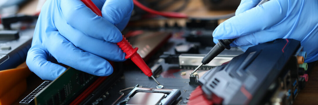 Hands are repairing electronic device, soldering