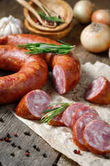 Smoked sausage on a wooden table. Rustic style.