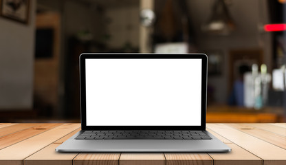 Laptop with blank screen on wooden table