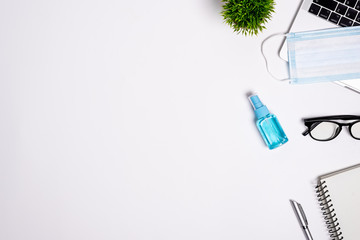 The equipment to protect COVID-19, blue mask and hand cleaner gel for preparing to work from home Isolated on white background concept.