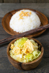 Fried cabbage and fried egg in oyster sauce, Rice in wooden dish.