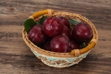 Plum heap in the wooden basket