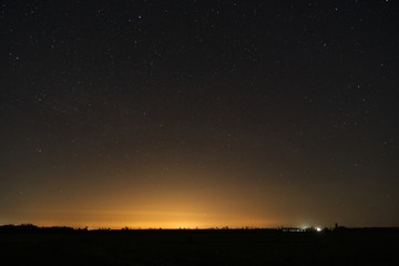 Fototapeta na wymiar A starry night over a farmers field