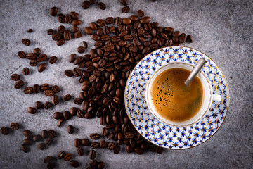 Cup of espresso and coffee beans.