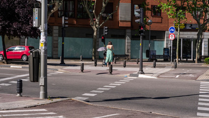 Obraz premium Madrid, Spain / march 12, 2020.mother crossing a crosswalk with her baby's stroller in madrid.Arganzuela.Covid19 protocol