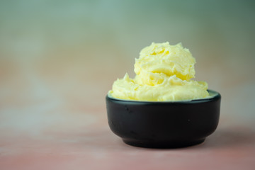 Soft butter in black bowl