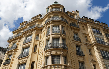 Fototapeta na wymiar Traditional French house with typical balconies and windows. Paris.