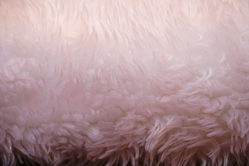 Background with synthetic fake fur texture in light pink color
