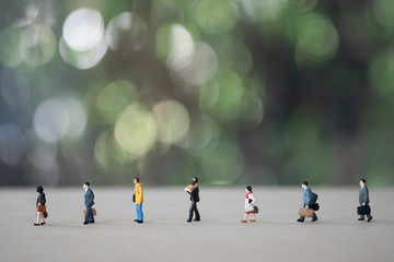 Miniature people in public and keep distance in public society people. Concept of social distancing...