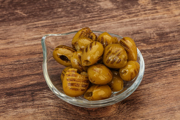 Green grilled olives in the bowl