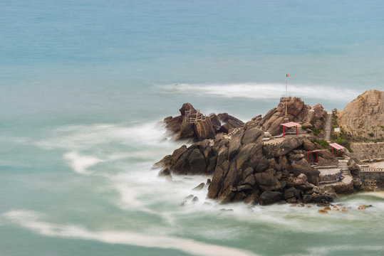 Long exposure photography of the sea waves breaking against the rocks of the breakwater at Formosa beach in Santa Cruz