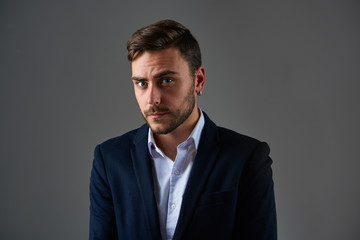 Close up portrait young man businessman. Caucasian guy business suit studio gray background.