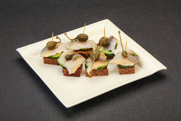 Herring fillet canape with caperberry