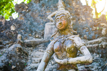 Ancient stone statues in Secret Buddhism Magic Garden, Koh Samui, Thailand. A place for relaxation and meditation. magic garden of the Buddha
