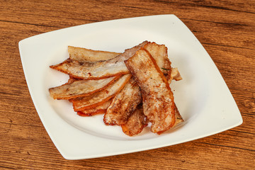 Roasted juicy bacon in the plate