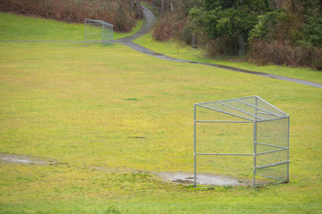 Wet play fields with chainlink fence baseball backstops
