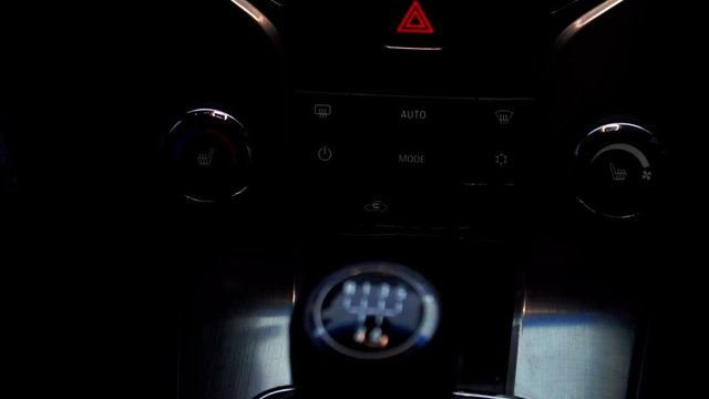 a man in a car switches the manual transmission close up