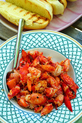 Plate of sautéed lobster with toasted bun on the side