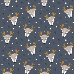 Seamless pattern with reindeer faces on dark background. Cute children textile design. Vetor illustration. © Alisa
