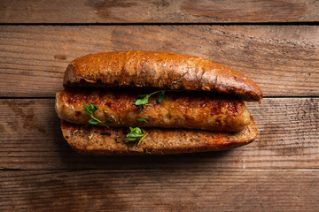 Tasty fresh hot dogs with grilled sausage on the rustic background. Selective focus. Shallow depth of field.