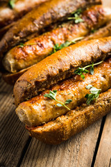 Tasty fresh hot dogs with grilled sausage on the rustic background. Selective focus. Shallow depth of field.