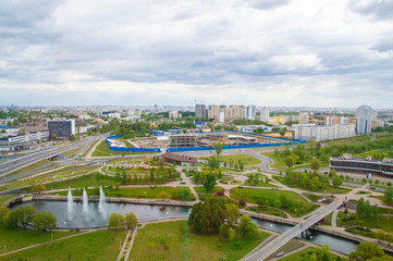 Fototapeta premium Top view of the city landscape. Buildings and roads in summer. 24 May 2020. Minsk. Belarus