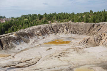 Amazing kaolin clay marsian landscape quarry open pit at summer day