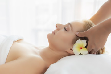 Beauty young woman enjoy massage in spa salon at luxury resort or hotel. Customer receiving face...