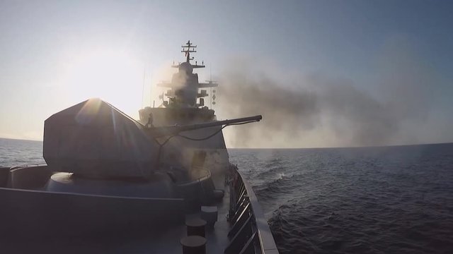 View from the side of a warship at firing from cannons (GoPro)
