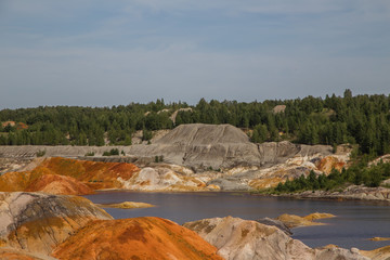 Fototapeta na wymiar Amazing kaolin clay marsian landscape quarry open pit at summer day