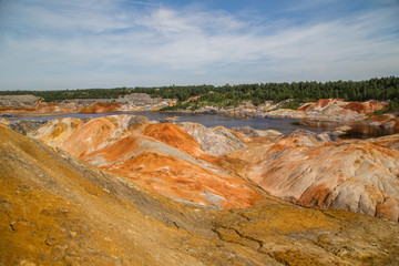 Amazing kaolin clay marsian landscape quarry open pit at summer day