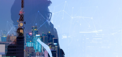 Double exposure of Asian woman using smart phone and Telecommunication tower with 5G cellular network antenna on smart city background
