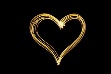Long exposure photograph of neon gold colour in an abstract heart shape outline, parallel lines...