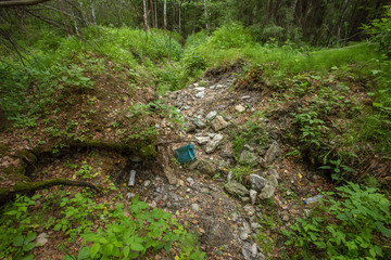 Old abandoned emerald gems mine open pit in forest