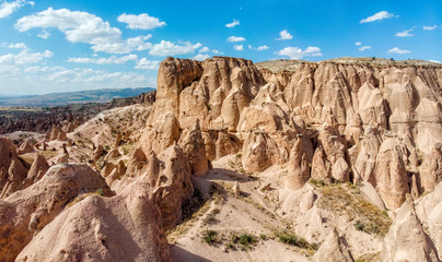 Aerial view of Goreme National Park, Tarihi Milli Parki, Turkey. The typical rock formations of Cappadocia with fairy chimneys and desert landscape. Travel destinations, holidays and adventure