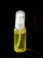 Tube with a yellow sanitizer on a black background