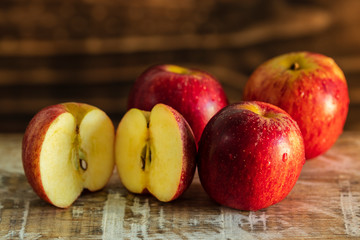ripe red apples, wooden background