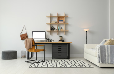 Stylish room interior with modern comfortable workplace