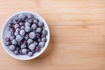 frozen blackcurrant on a wooden Board. Summer season.