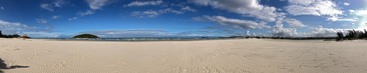 Fototapeta na wymiar Panoramic landscape of Ibiraquera beach in Santa Catarina Brazil, in a day without anyone.