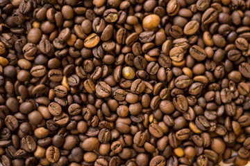 Lots of roasted coffee beans on a white background