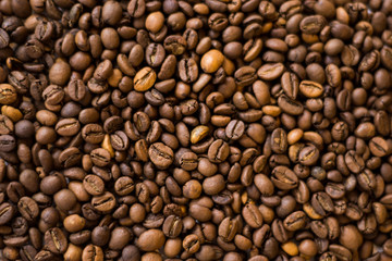 Lots of roasted coffee beans on a white background