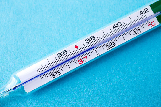 analog mercury thermometer with 37,7 °C of temperature, fever, flu, corona virus, covid19