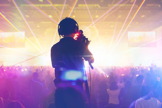 Silhouette of the cameraman working concert Cameraman shooting video production camera videographer