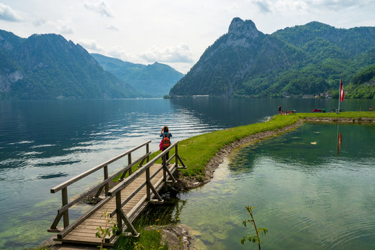 Tourist taking picture of the stunning mountain scenery at the Traunsee lake at Traunkirchen, Salzkammergut region, OÖ, Austria