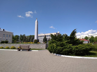 stella in the square, blue sky, green spaces