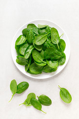 Fresh spinach leaves on white background